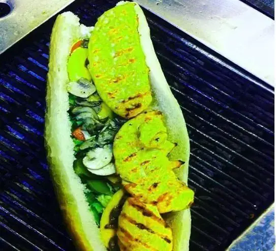 ساندویچ بزرگ مرغ گریل شده رنگی با قارچ و کاهو، یک غذای خوشمزه و سالم برای منوی متنوع دومینوز پیتزا