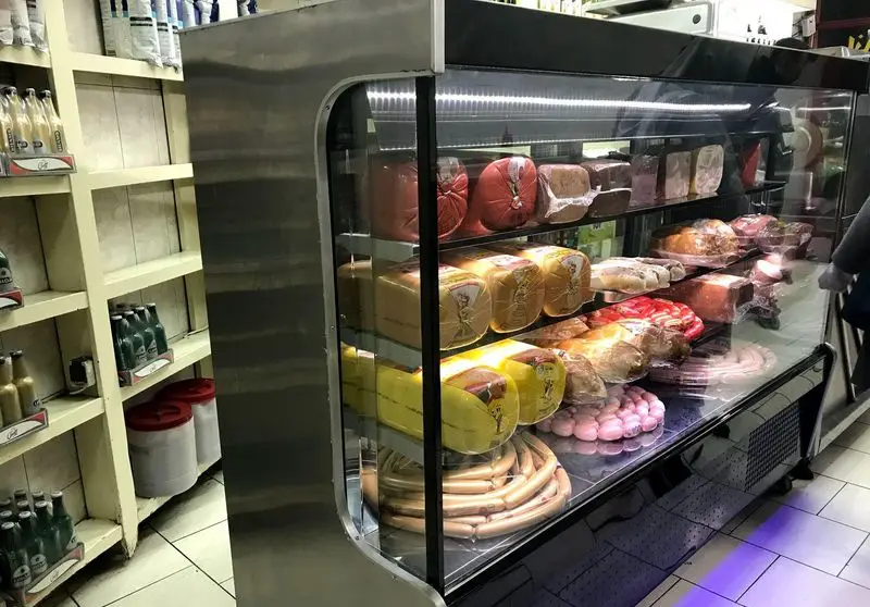 نمایی از یخچال ویترینی پر از سوسیس، کالباس و فرآورده های گوشتی تازه و باکیفیت در ساندویچی آرزو برای ساندویچ‌های خوشمزه.