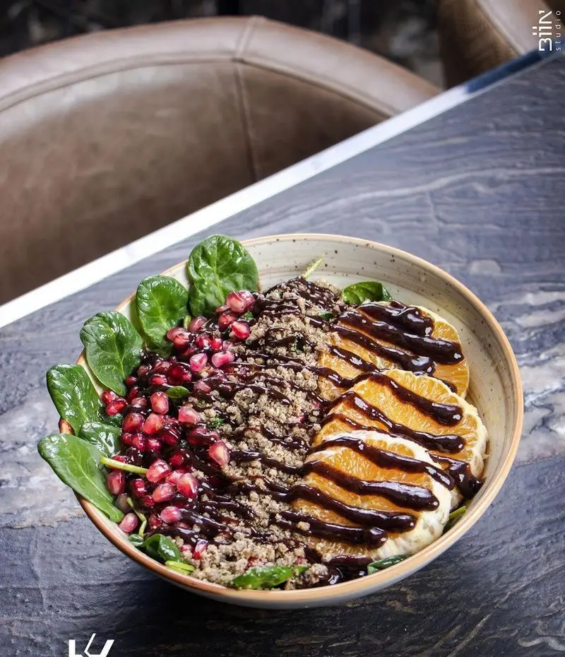 کاسه صبحانه سالم کافه رستوران کالوک: ترکیبی از اسفناج تازه، انار، پرتقال و گرانولا با سس شکلات. مناسب برای انرژی روزانه.