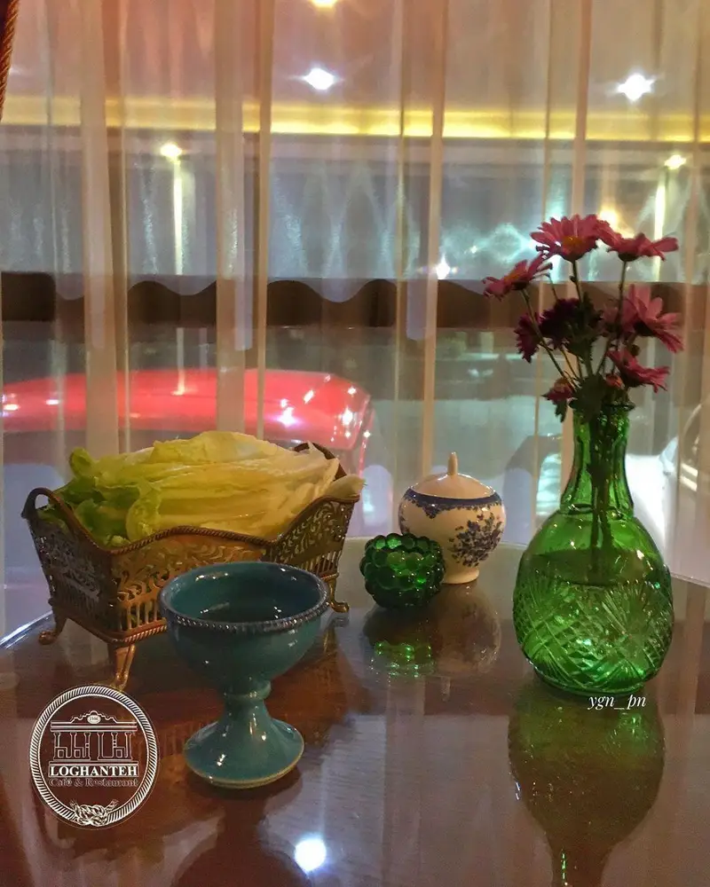 میز شیک کافه و رستوران لقانطه با سبزی خوردن، گل، و ظروف سنتی؛ فضایی دلنشین برای صرف غذای ایرانی.