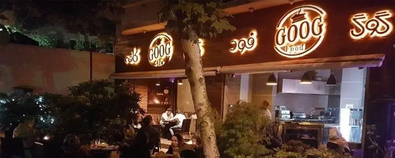 کافه رستوران گوگ در شب با فضای باز و مشتریان در حال لذت بردن از محیط دلنشین، نشان‌دهنده تجربه‌ای خاص برای غذا و نوشیدنی.