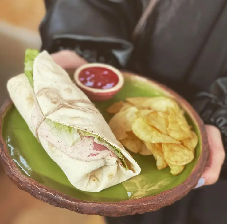 ساندویچ رپ لذیذ کافه گالری رحیمیه با نان تازه، کاهو، سس ویژه و چیپس ترد سیب زمینی. تجربه‌ای خوش طعم و دلنشین.