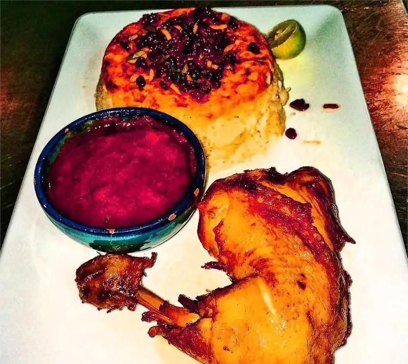 یک بشقاب ته چین زرشک پلو با مرغ تنوری آبدار، سس انار و لیمو در رستوران ایرانی دیگی تنوری. غذایی لذیذ برای ناهار و شام.