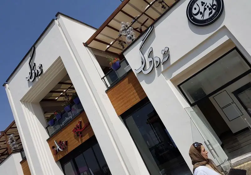 نمای لوکس و مدرن رستوران ته دیگ و کافه شیرون. سردر ورودی شیک با تابلوهای برجسته و طراحی چشم‌نواز ساختمان تجاری.