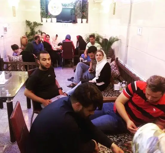 مشتریان شاد در کافه عمو امید، مشغول دورهمی دوستانه در فضایی دنج و دلنشین. تجربه لحظاتی خاص با سرویس‌دهی ممتاز.