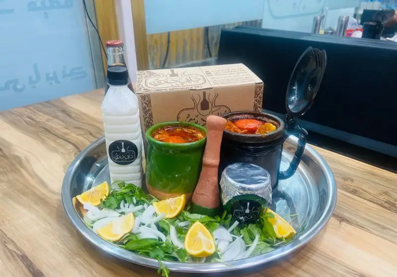 سرویس کامل دیزی سنگی و سنتی رستوران دایی دیزی، شامل آبگوشت، دوغ، سبزی تازه، پیاز و لیمو ترش در یک سینی فلزی.