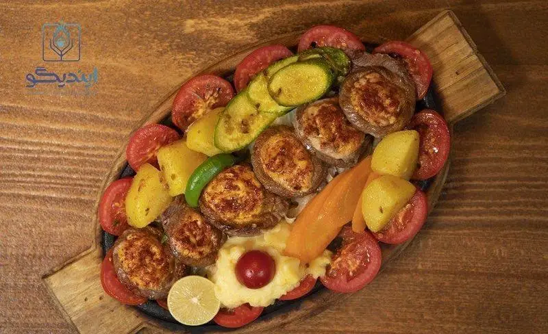 یک سینی غذای خوشمزه و مجلل شامل گوشت برگ، قارچ شکم‌پر، گوجه، سیب‌زمینی و سبزیجات متنوع کافه رستوران زیرزمین.