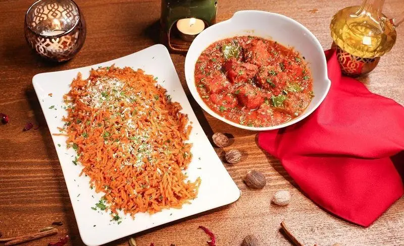 سفارش غذای هندی لذیذ از منوی کافه رستوران زیرزمین شامل چیکن کاری قرمز و پلو برنج نارنجی برای تجربه‌ای بی‌نظیر.