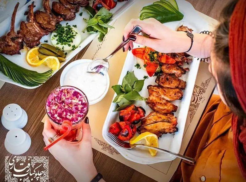 میز رنگین رستوران رفتاری: کباب شیشلیک، بال و کتف، نوشیدنی سنتی با گل، ماست و مخلفات. طعم اصیل غذای ایرانی.