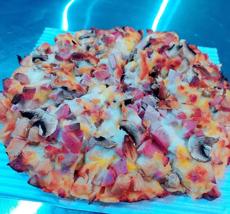 پیتزای مخصوص فست فود آرام ناز، پر از قارچ تازه، ژامبون لذیذ و پنیر طلایی. یک غذای آماده دلچسب و محبوب.