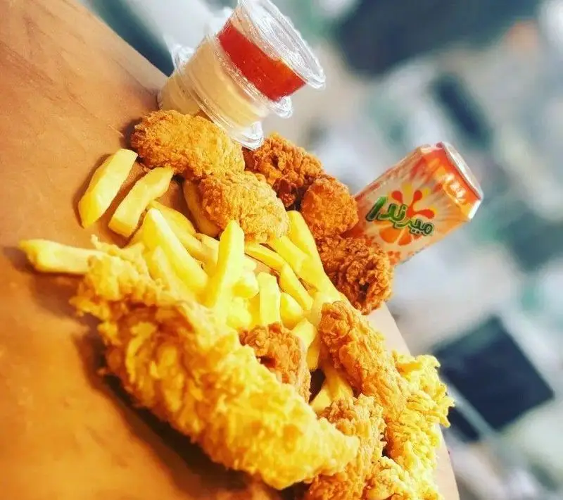 سفارش فست فود لذیذ شامل مرغ سوخاری، سیب زمینی سرخ کرده ترد، سس‌های متنوع و نوشابه میرندا از ساندویچ‌های حمید و مجید.