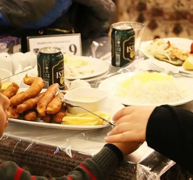 تجربه یک وعده غذایی لذیذ در سفره خانه سنتی باغ فردوس با انواع خوراک ایرانی مانند برنج، ماهی سوخاری و نوشیدنی ایستک.