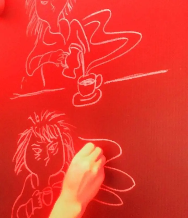 تصویری خلاقانه از کافه لند: طراحی با گچ سفید روی پس زمینه قرمز، نمایش زنی خسته قبل و پرانرژی بعد از قهوه صبحگاهی.