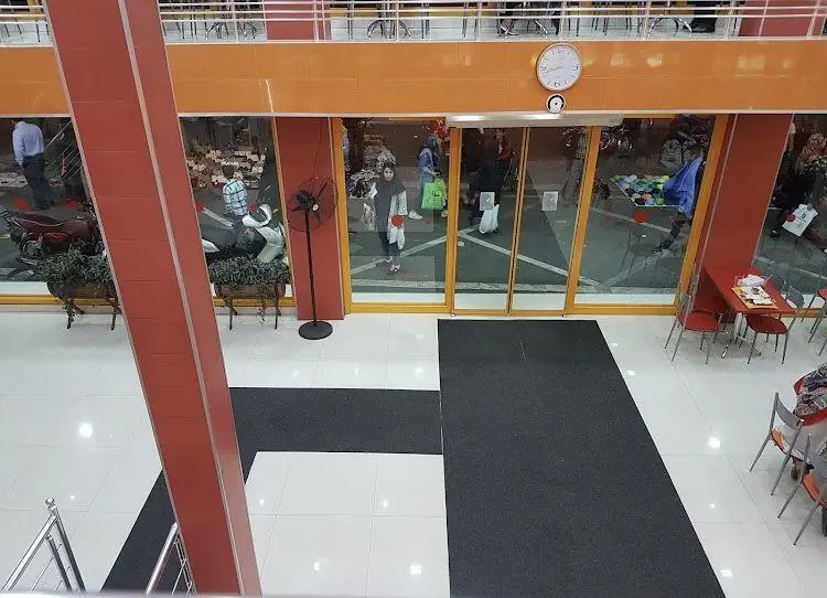 محیط داخلی و ورودی مدرن فست فود استار برگر با میز و صندلی، آماده ارائه خدمات به مشتریان عزیز و علاقه‌مندان به برگر.