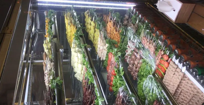 جگرسرای نیلوفر: ویترین شیک کباب‌های تازه. سیخ‌های جگر، جوجه کباب، کوبیده و انواع گوشت با سبزیجات معطر آماده طبخ.