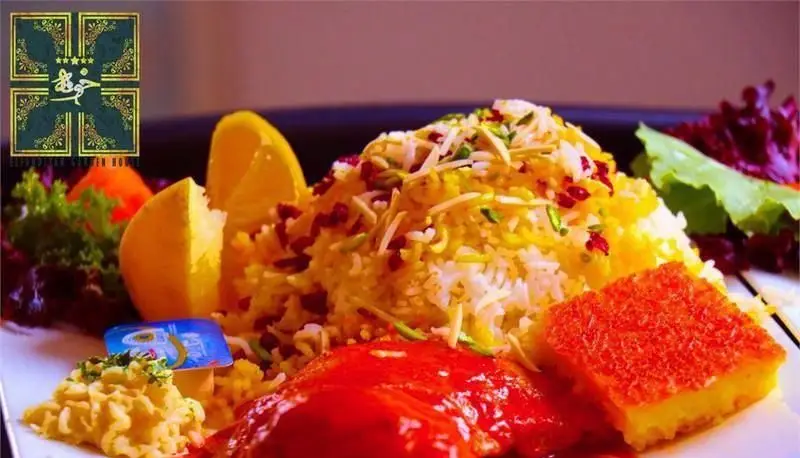 تصویری جذاب از زرشک پلو با مرغ، ته چین زعفرانی و برنج اعلا. غذای اصیل و باکیفیت ایرانی در رستوران بین المللی خوارزمی با طعم بی‌نظیر.