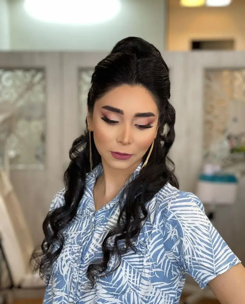 آرایش شیک و مدل موی زیبای زنانه در آرایشگاه آنا. میکاپ چشم صورتی، رژ لب تیره و موهای بلند فر برای زیبایی بیشتر