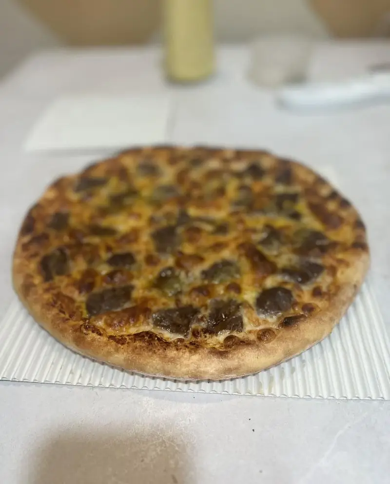 پیتزای خوش طعم و وسوسه‌انگیز پی پزا با تاپینگ‌های تازه گوشت و پنیر، انتخابی ایده‌آل برای یک وعده لذیذ.