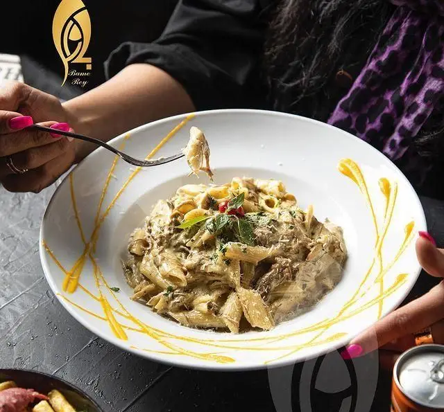 لذت چشیدن پاستای خامه‌ای کافه رستوران بام ری، غذایی خوشمزه و خاص که در ظروفی زیبا سرو شده است. تجربه‌ای دلپذیر در محیطی شیک.