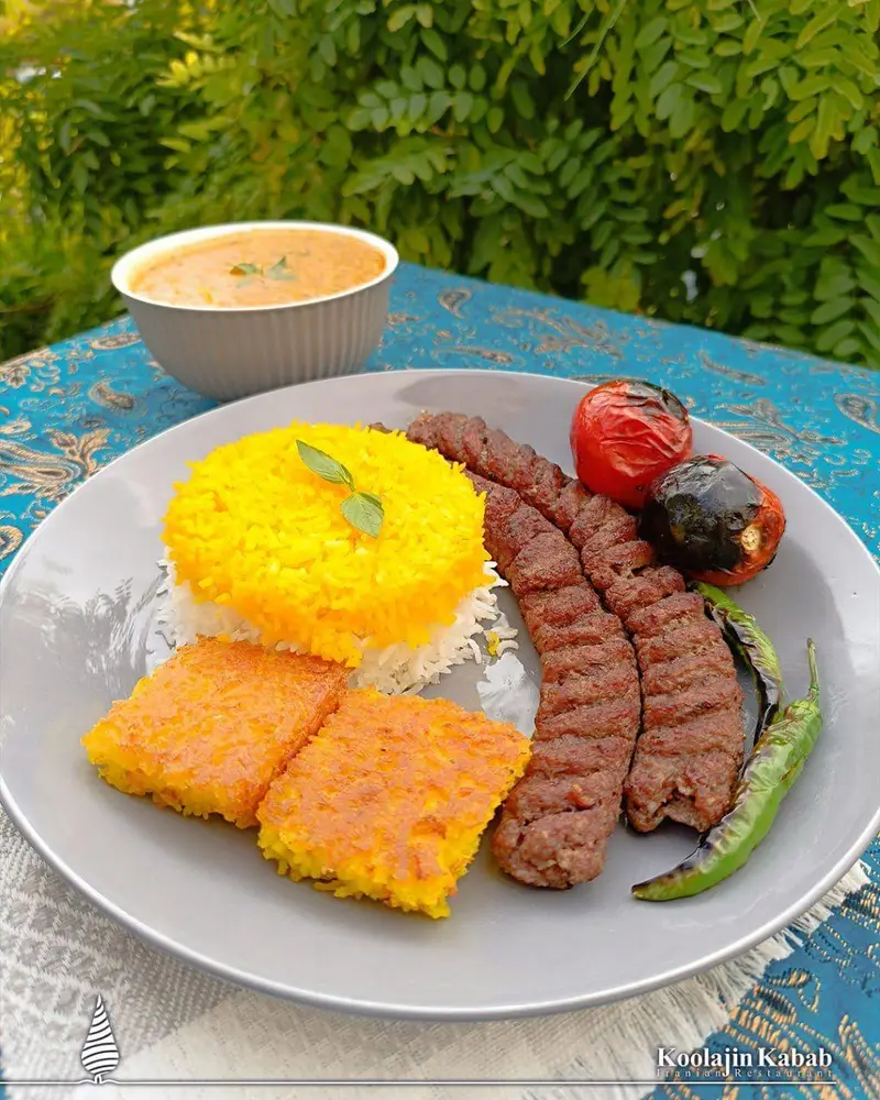 کباب کوبیده لذیذ از رستوران آش و حلیم کولاژین سعادت آباد، همراه چلو زعفرانی، ته دیگ برشته، گوجه و فلفل کبابی.